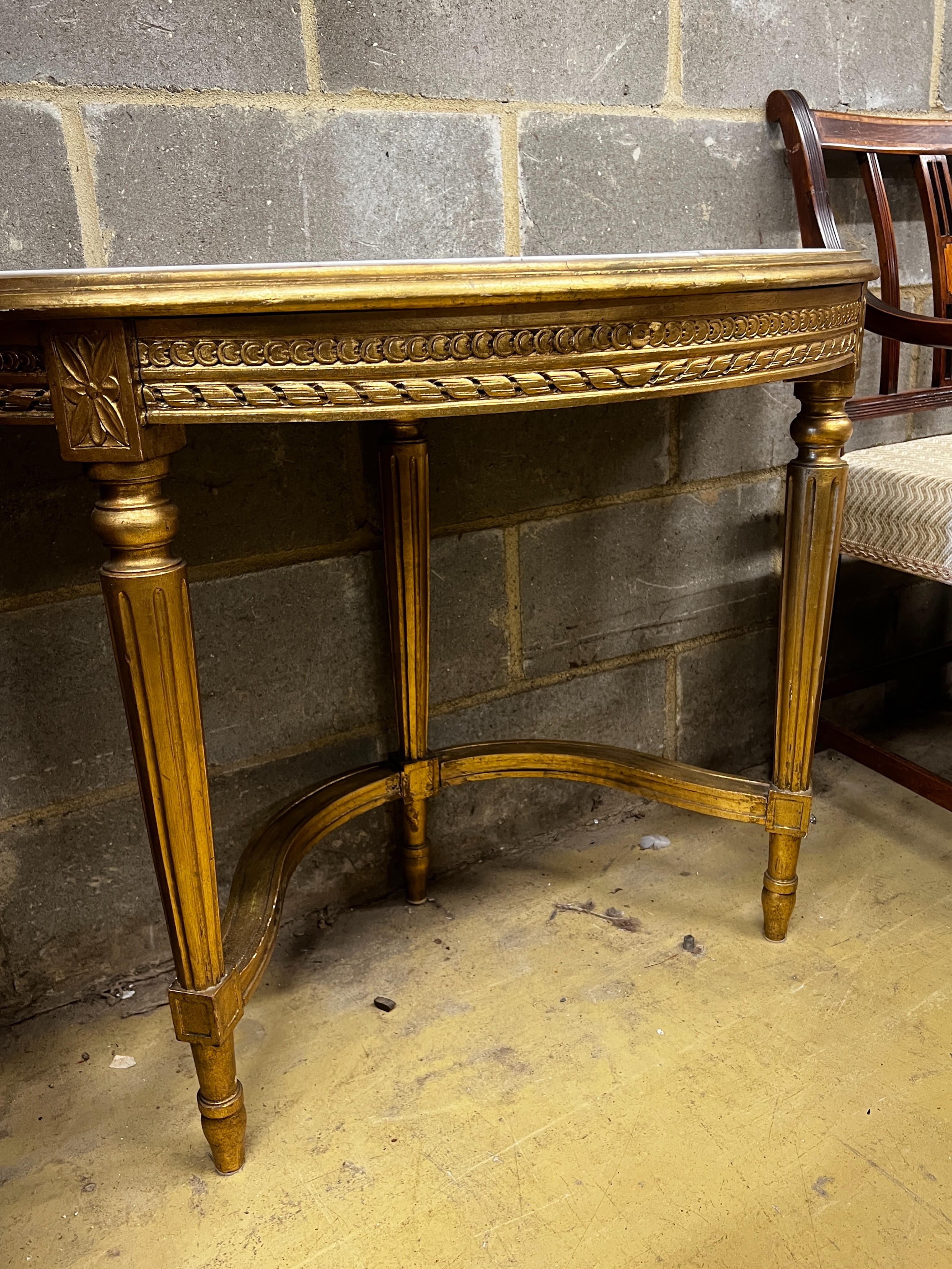 A Louis XVI style carved giltwood marble top D shaped console table, width 110cm, depth 50cm, height 73cm